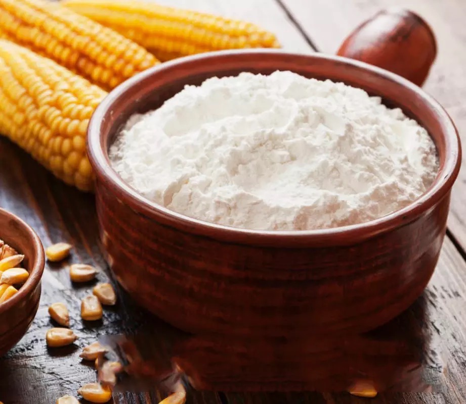 Corn starch in a bowl beside corn