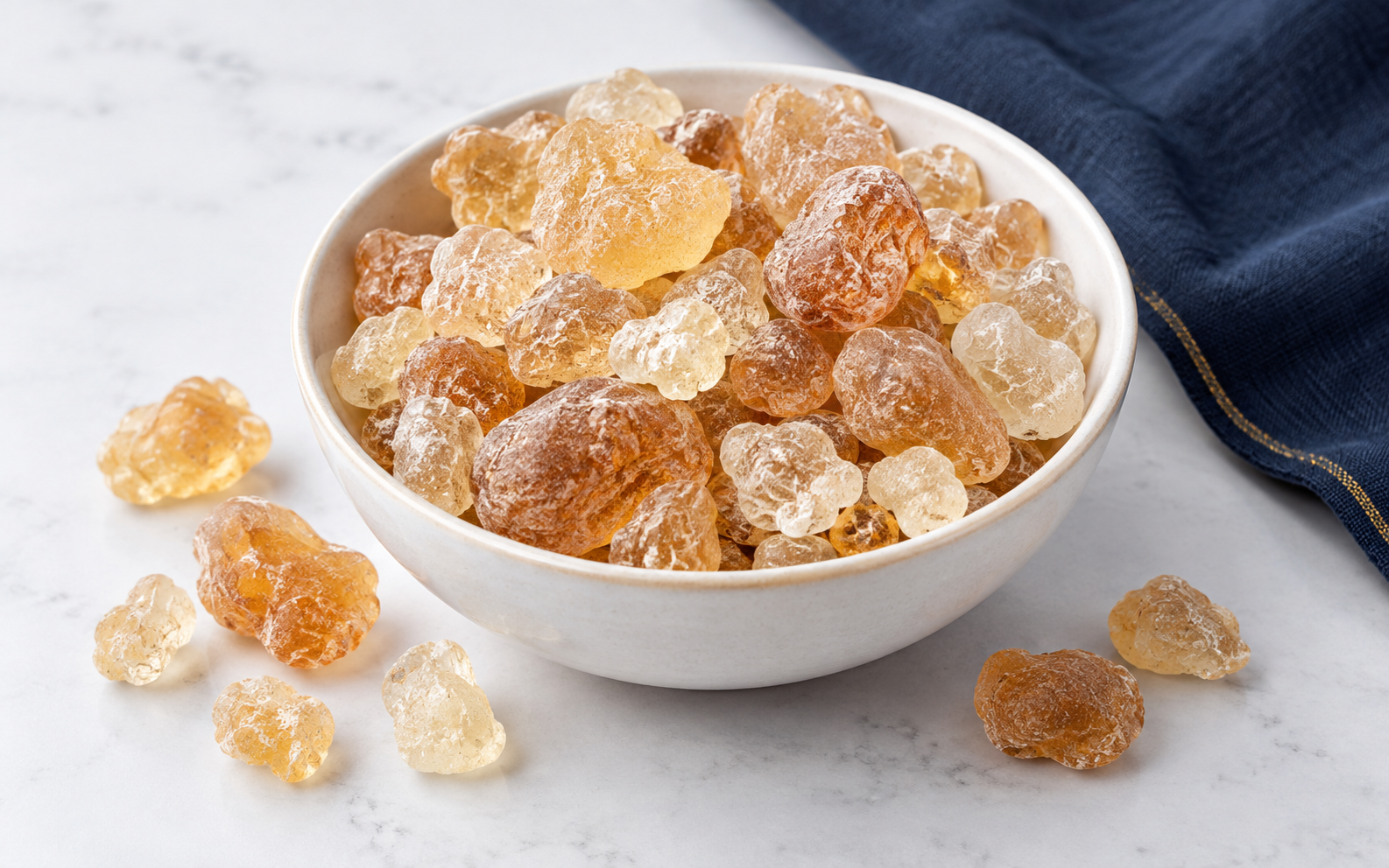 Natural gum arabic nodules displayed in a ceramic bowl